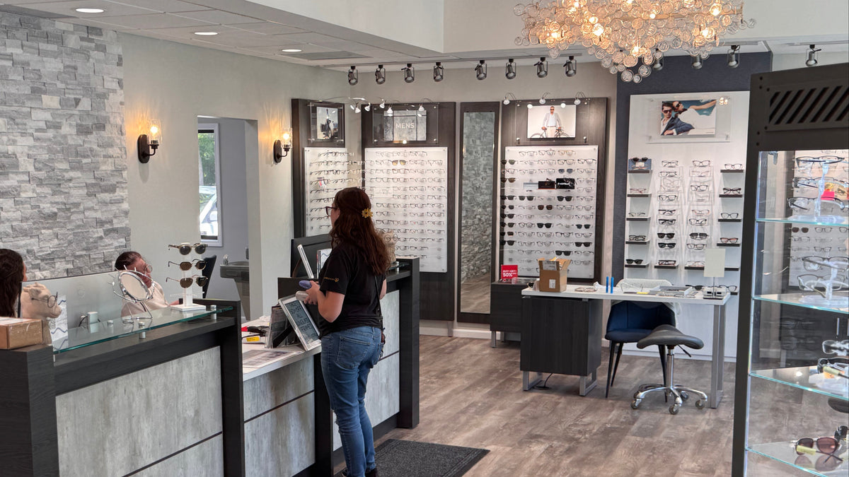 Optometrist's office with customers and staff at the counter